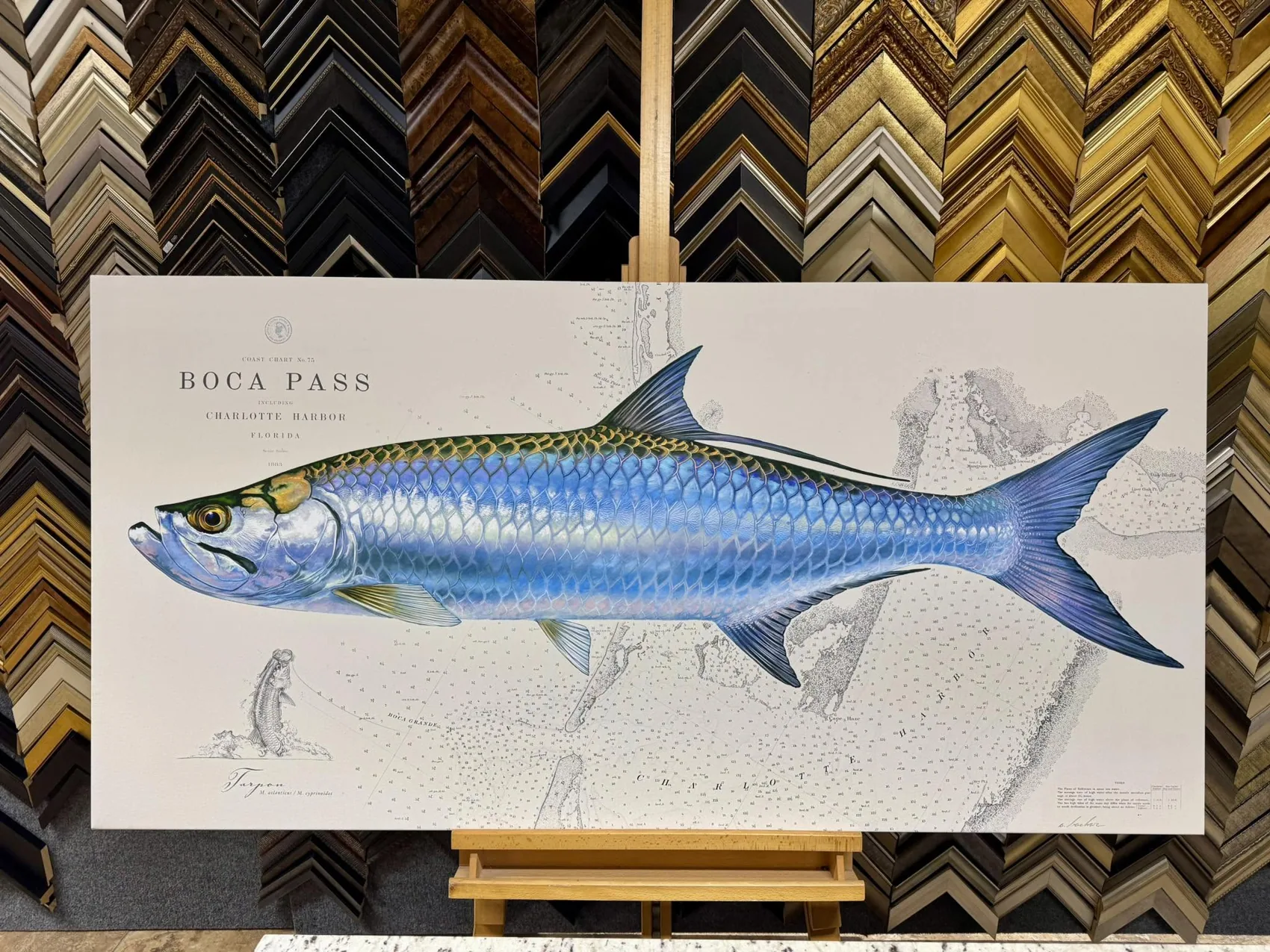Custom framed tarpon artwork displayed in the studio